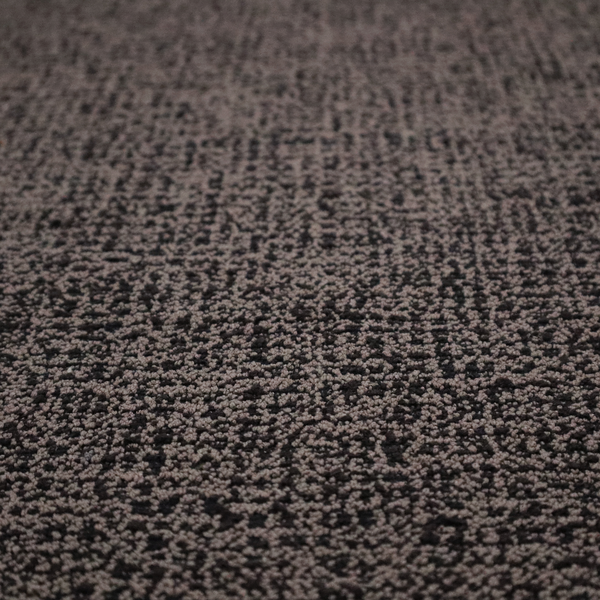 A textured, woven fabric featuring a complex pattern of dark brown, black, and beige threads, creating a speckled and mottled appearance.