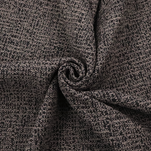 A textured, woven fabric featuring a complex pattern of dark brown, black, and beige threads, creating a speckled and mottled appearance.