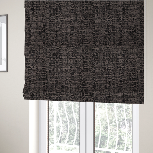 The fabric used to create these Roman blinds is a textured, woven fabric featuring a complex pattern of dark brown, black, and beige threads, creating a speckled and mottled appearance.