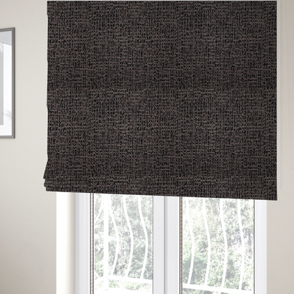 The fabric used to create these Roman blinds is a textured, woven fabric featuring a complex pattern of dark brown, black, and beige threads, creating a speckled and mottled appearance.