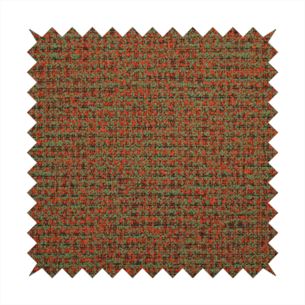 A textured, woven fabric featuring a complex pattern of red, green, and dark threads, creating a speckled and mottled appearance.