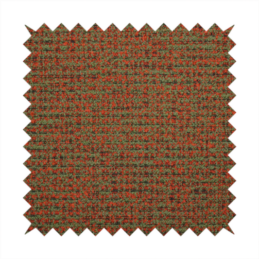 A textured, woven fabric featuring a complex pattern of red, green, and dark threads, creating a speckled and mottled appearance.