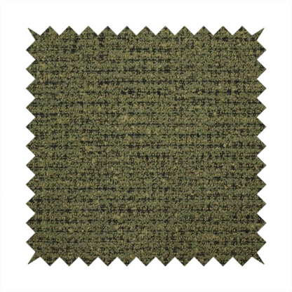 A textured, woven fabric featuring a complex pattern of green, dark, and beige threads, creating a speckled and mottled appearance.