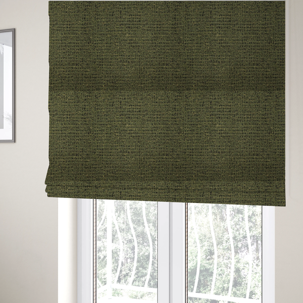 The fabric used to create these Roman blinds is a textured, woven fabric featuring a complex pattern of green, dark, and beige threads, creating a speckled and mottled appearance.