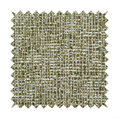 A textured, woven fabric featuring a complex pattern of green, dark, and white threads, creating a speckled and mottled appearance.
