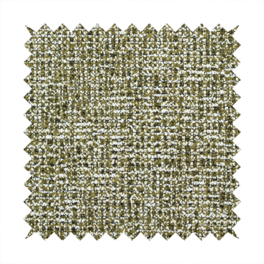 A textured, woven fabric featuring a complex pattern of green, dark, and white threads, creating a speckled and mottled appearance.