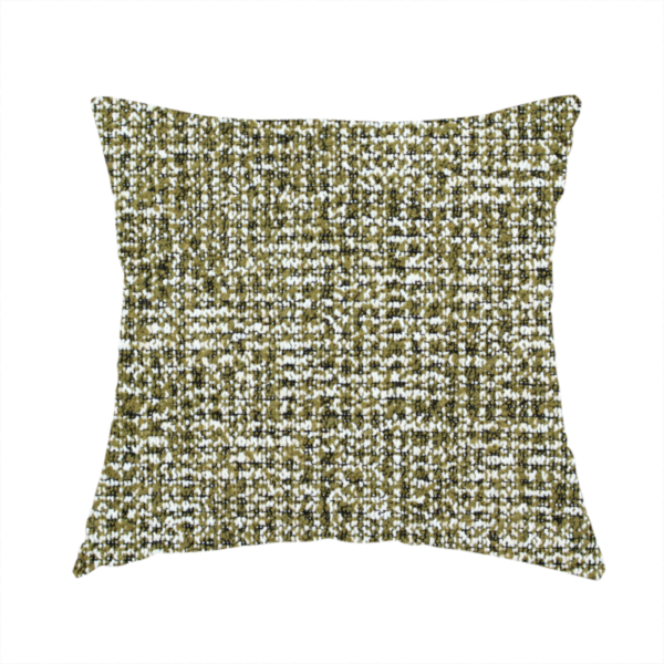 The fabric used to create this handmade cushion is a textured, woven fabric featuring a complex pattern of green, dark, and white threads, creating a speckled and mottled appearance.