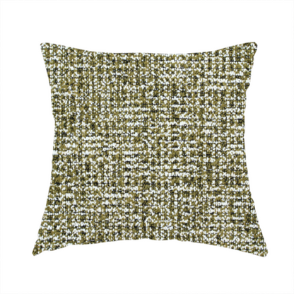 The fabric used to create this handmade cushion is a textured, woven fabric featuring a complex pattern of green, dark, and white threads, creating a speckled and mottled appearance.