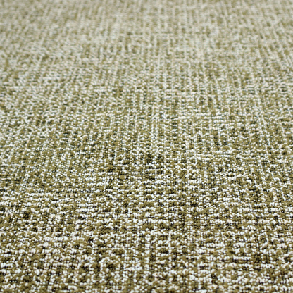 A textured, woven fabric featuring a complex pattern of green, dark, and white threads, creating a speckled and mottled appearance.