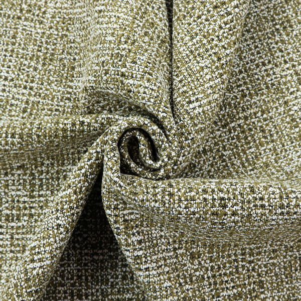 A textured, woven fabric featuring a complex pattern of green, dark, and white threads, creating a speckled and mottled appearance.