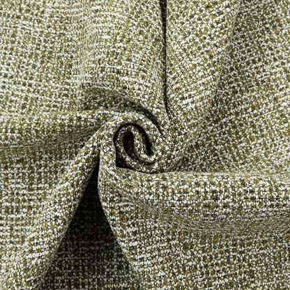 A textured, woven fabric featuring a complex pattern of green, dark, and white threads, creating a speckled and mottled appearance.