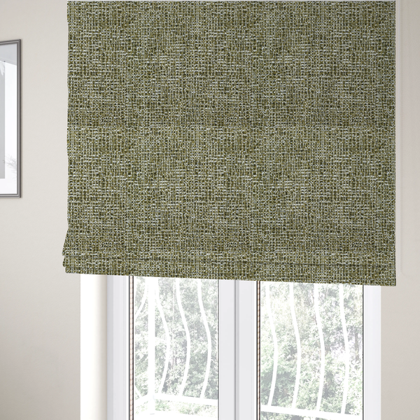 The fabric used to create these Roman blinds is a textured, woven fabric featuring a complex pattern of green, dark, and white threads, creating a speckled and mottled appearance.
