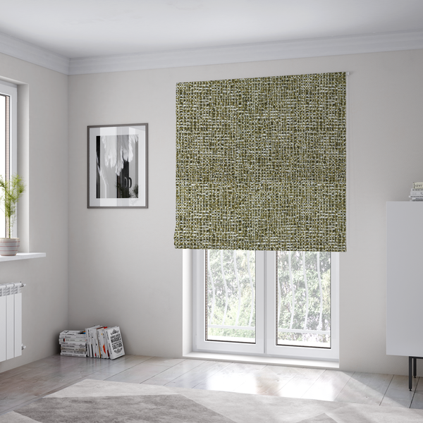 The fabric used to create these Roman blinds is a textured, woven fabric featuring a complex pattern of green, dark, and white threads, creating a speckled and mottled appearance.