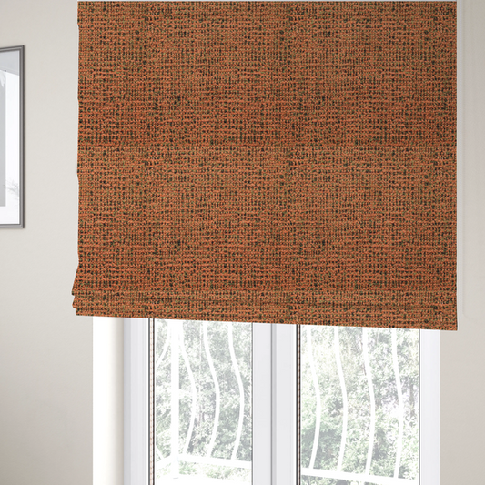 The fabric used to create these Roman blinds is a textured, woven fabric featuring a complex pattern of orange, green, and dark threads, creating a speckled and mottled appearance.
