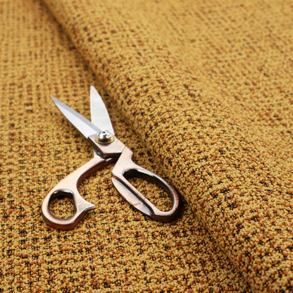 A textured, woven fabric featuring a complex pattern of yellow, dark, and beige threads, creating a speckled and mottled appearance.