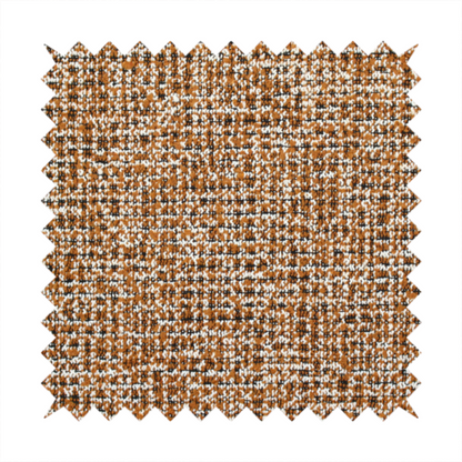 A textured, woven fabric featuring a complex pattern of brown, white, and dark threads, creating a speckled and mottled appearance.