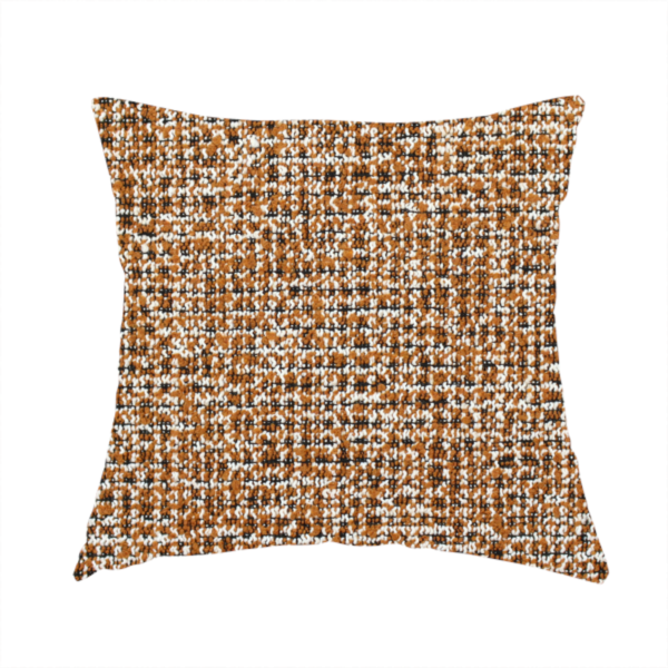 The fabric used to create this handmade cushion is a textured, woven fabric featuring a complex pattern of brown, white, and dark threads, creating a speckled and mottled appearance.