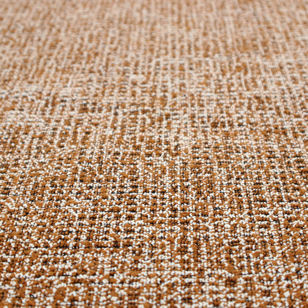 A textured, woven fabric featuring a complex pattern of brown, white, and dark threads, creating a speckled and mottled appearance.
