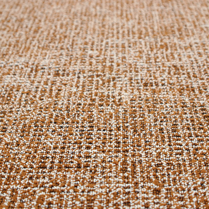 A textured, woven fabric featuring a complex pattern of brown, white, and dark threads, creating a speckled and mottled appearance.