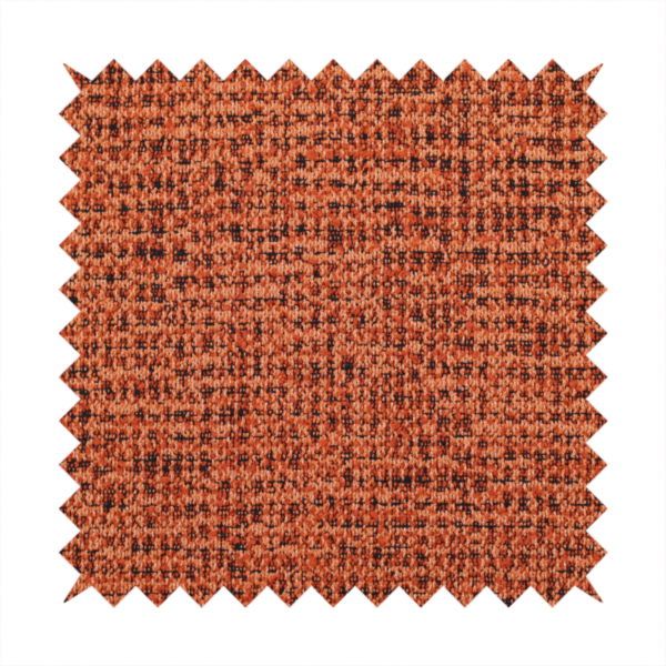 A textured, woven fabric featuring a complex pattern of orange, dark, and beige threads, creating a speckled and mottled appearance.