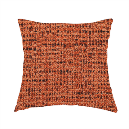 the fabric used to create this handmade cushion is a textured, woven fabric featuring a complex pattern of orange, dark, and beige threads, creating a speckled and mottled appearance.