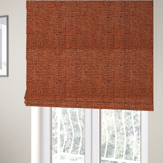 The fabric used to create these Roman blinds is a textured, woven fabric featuring a complex pattern of orange, dark, and beige threads, creating a speckled and mottled appearance.