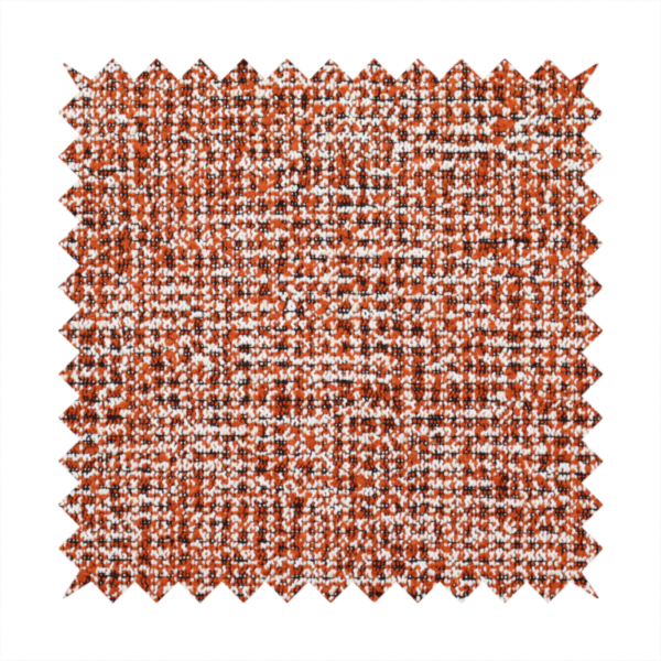 A textured, woven fabric featuring a complex pattern of orange, white, and dark threads, creating a speckled and mottled appearance.