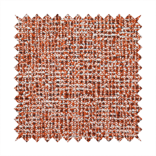 A textured, woven fabric featuring a complex pattern of orange, white, and dark threads, creating a speckled and mottled appearance.