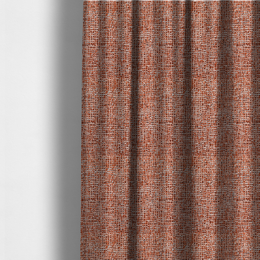 The fabric used to create these made-to-measure curtains is a textured, woven fabric featuring a complex pattern of orange, white, and dark threads, creating a speckled and mottled appearance.
