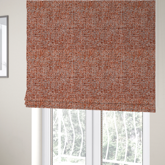 The fabric used to create these Roman blinds is a textured, woven fabric featuring a complex pattern of orange, white, and dark threads, creating a speckled and mottled appearance.