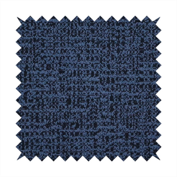 A textured, woven fabric featuring a complex pattern of blue, dark, and navy threads, creating a speckled and mottled appearance.