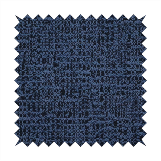 A textured, woven fabric featuring a complex pattern of blue, dark, and navy threads, creating a speckled and mottled appearance.