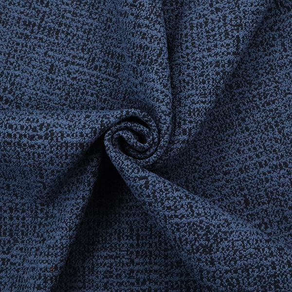 A textured, woven fabric featuring a complex pattern of blue, dark, and navy threads, creating a speckled and mottled appearance.