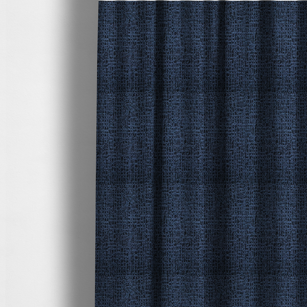 The fabric used to create these made-to-measure curtains is a textured, woven fabric featuring a complex pattern of blue, dark, and navy threads, creating a speckled and mottled appearance.