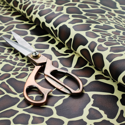 A seamless, repeating fabric pattern featuring a brown and cream giraffe print with a textured, leather-like finish on the dark spots.