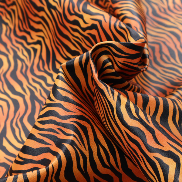 A vibrant, repeating tiger-stripe pattern featuring vertical black wavy stripes over an orange-to-yellow gradient background.