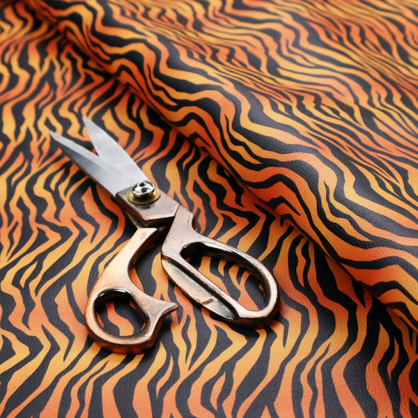 A vibrant, repeating tiger-stripe pattern featuring vertical black wavy stripes over an orange-to-yellow gradient background.