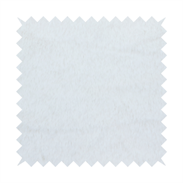 A snow-white faux fur. The material has a dense, soft pile with subtle shadows and highlights that showcase its fluffy, velvety texture.