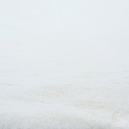 A snow-white faux fur. The material has a dense, soft pile with subtle shadows and highlights that showcase its fluffy, velvety texture.