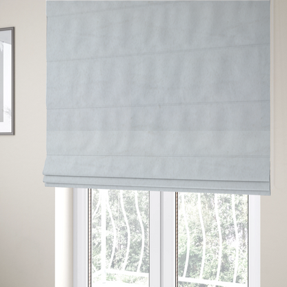 The fabric used to create these Roman blinds is a snow-white faux fur. The material has a dense, soft pile with subtle shadows and highlights that showcase its fluffy, velvety texture.