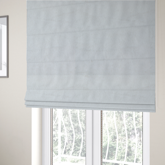 The fabric used to create these Roman blinds is a snow-white faux fur. The material has a dense, soft pile with subtle shadows and highlights that showcase its fluffy, velvety texture.
