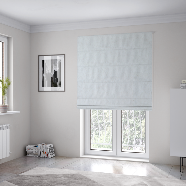 The fabric used to create these Roman blinds is a snow-white faux fur. The material has a dense, soft pile with subtle shadows and highlights that showcase its fluffy, velvety texture.