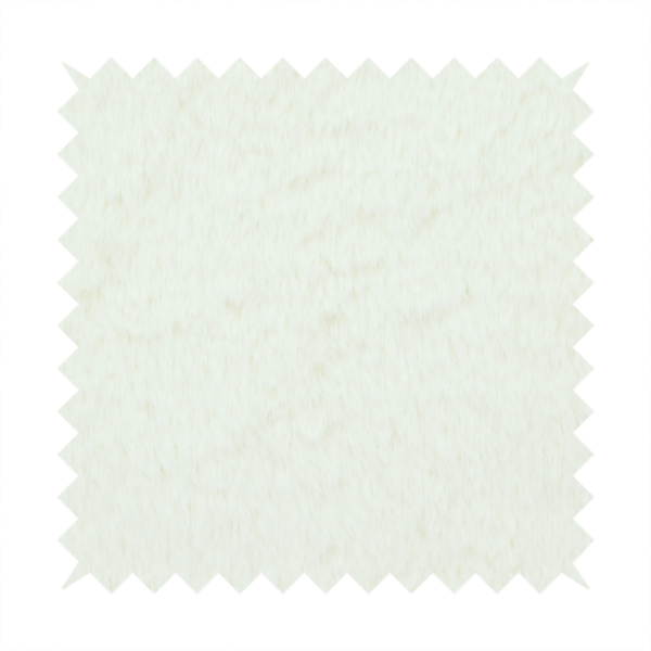 A cream-colored faux fur. The material features a thick, plush pile with a soft sheen, showing a warm ivory tint compared to pure white.