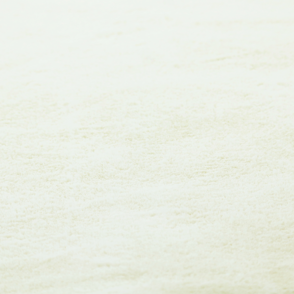 A cream-colored faux fur. The material features a thick, plush pile with a soft sheen, showing a warm ivory tint compared to pure white.