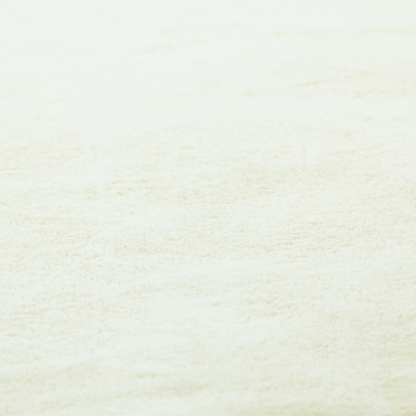 A cream-colored faux fur. The material features a thick, plush pile with a soft sheen, showing a warm ivory tint compared to pure white.