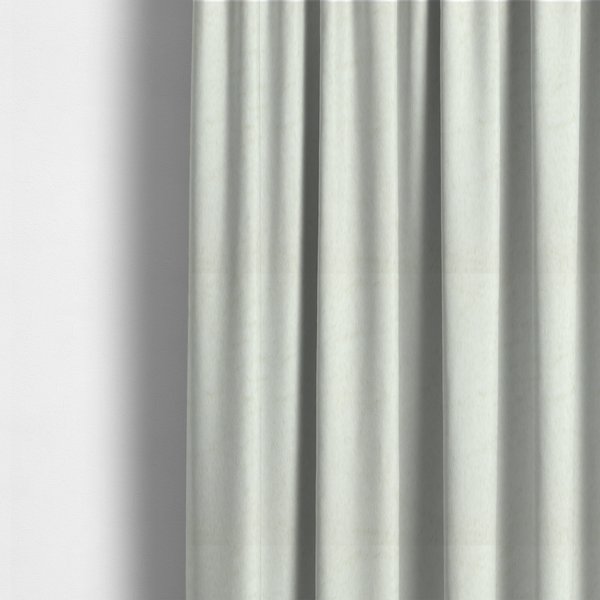 The fabric used to create these made-to-measure curtains is a cream-colored faux fur. The material features a thick, plush pile with a soft sheen, showing a warm ivory tint compared to pure white.