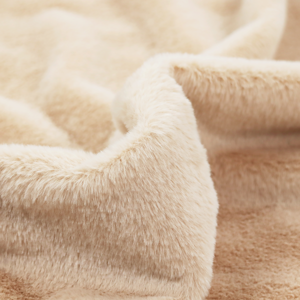 A high-quality faux fur fabric in a warm, sandy beige or light camel hue. The material features a dense, short-pile texture with a soft, uniform grain that gives it a velvety and plush appearance.
