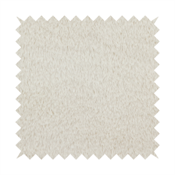 A plush faux fur fabric in a pale oatmeal or light greige shade. The material has a dense, short-pile texture that appears incredibly soft and velvety.