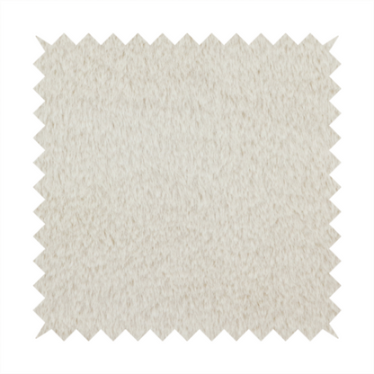 A plush faux fur fabric in a pale oatmeal or light greige shade. The material has a dense, short-pile texture that appears incredibly soft and velvety.