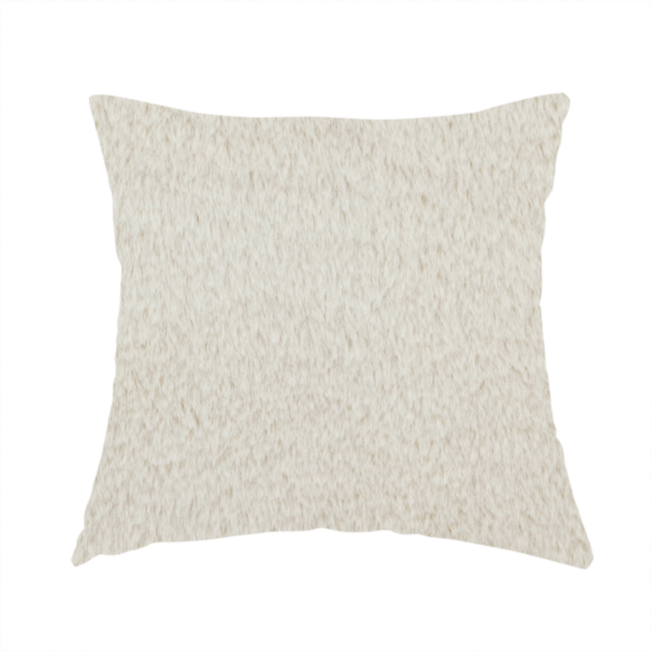 The fabric used to create this handmade cushion is a plush faux fur fabric in a pale oatmeal or light greige shade. The material has a dense, short-pile texture that appears incredibly soft and velvety.